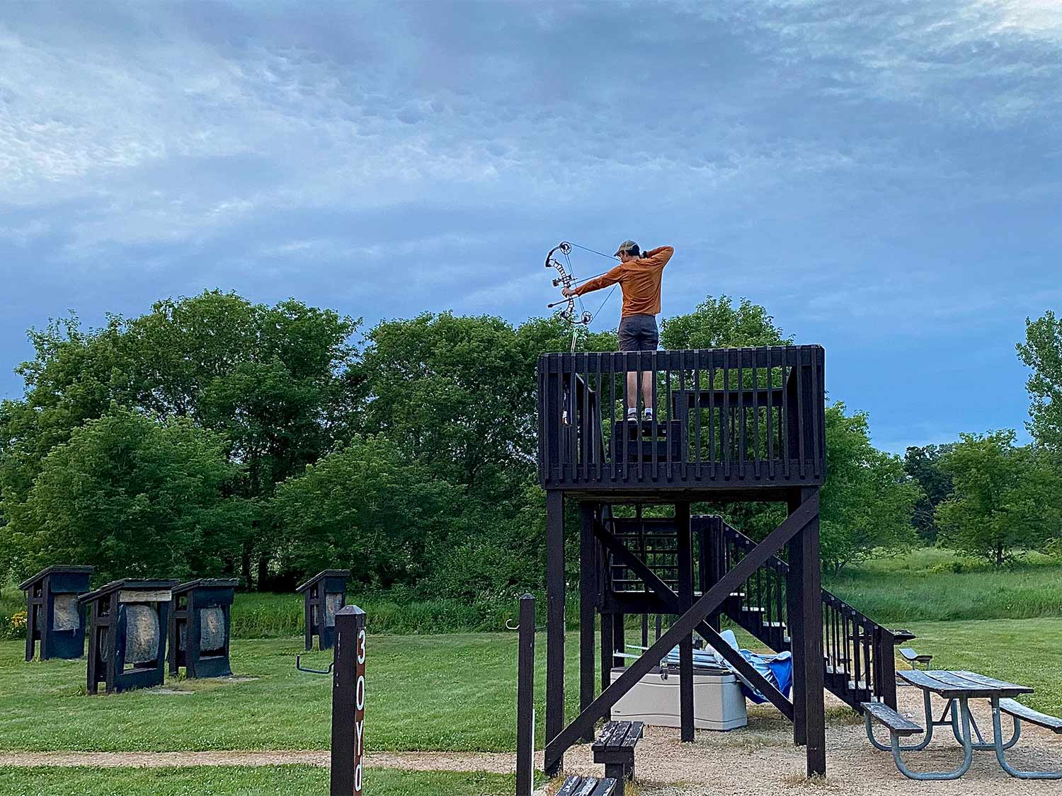 A bowhunter on a elevated shooting stand.