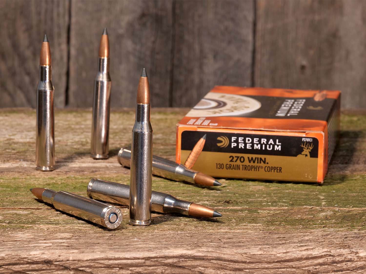 A box of federal premium rifle ammunition laying and standing on a table.
