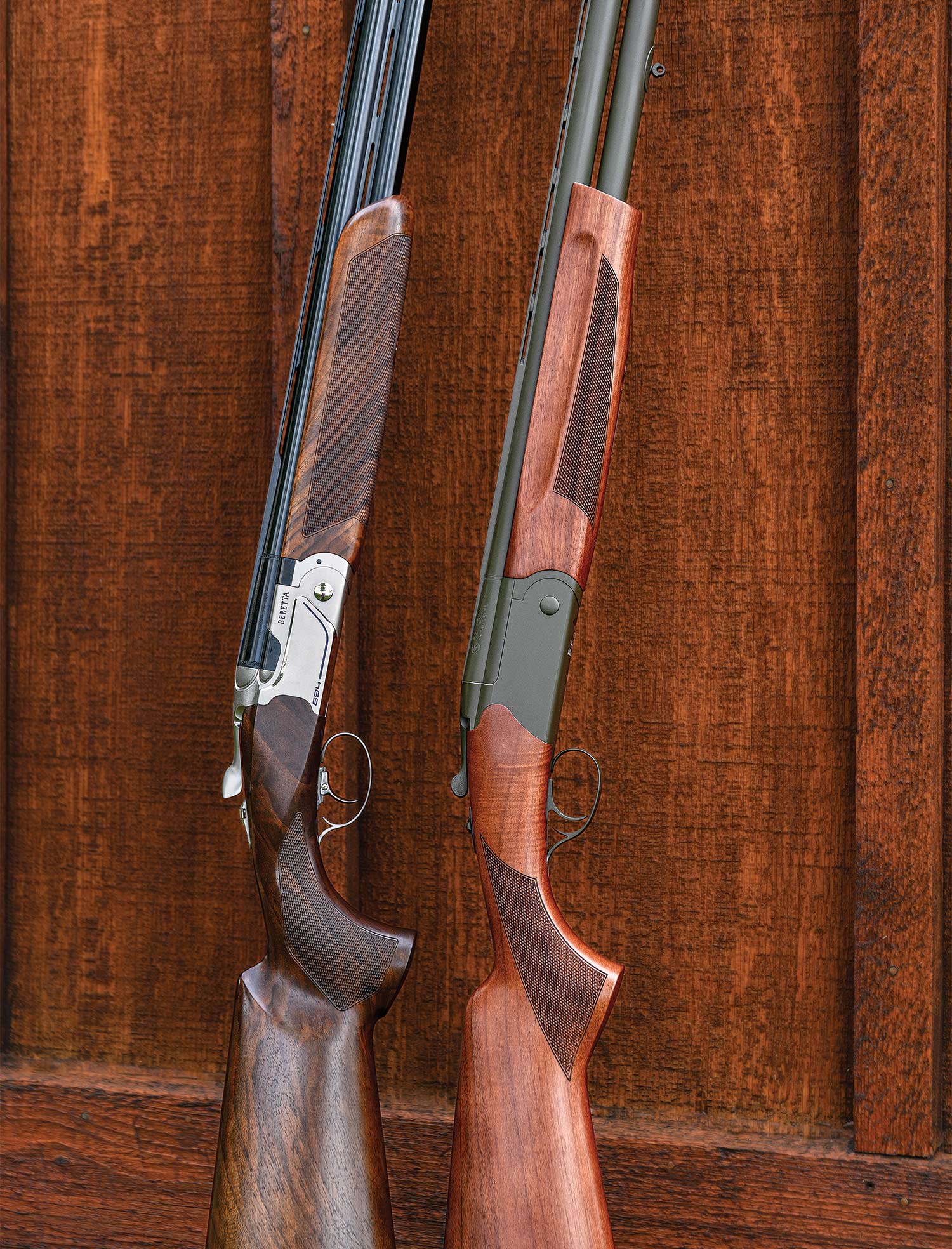 Two shotguns leaning against a wall.