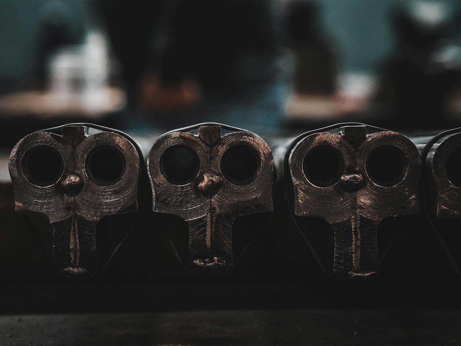a row of AYA sidelocks in side-by-side shotguns.