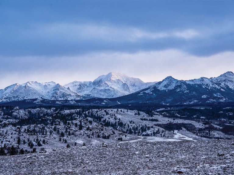 A large aerial view of a snowy mountainscape.