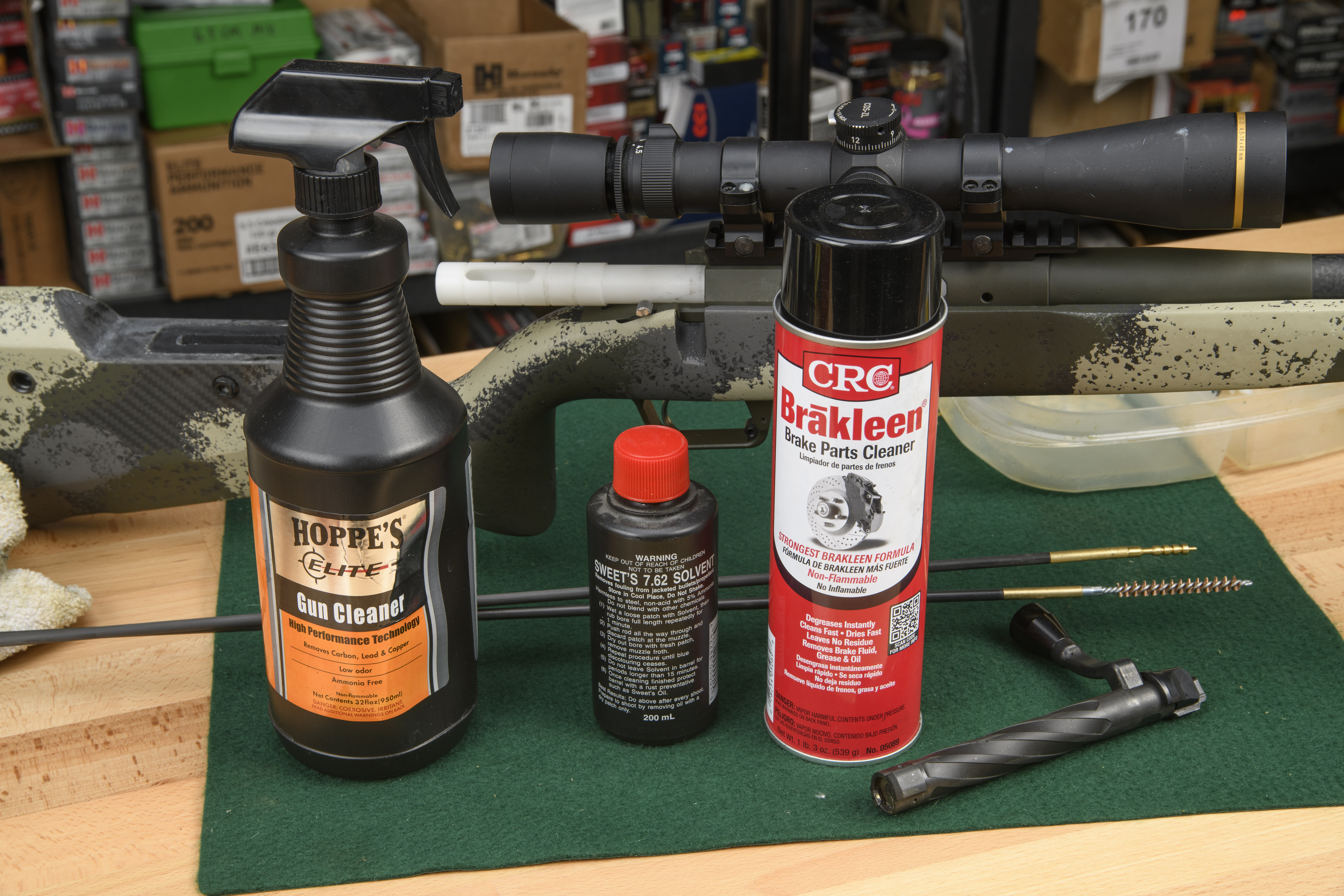 A spray bottle of Hoppe's Elite gun cleaner, Sweet's solvent, and Brakleen brake parts cleaner.