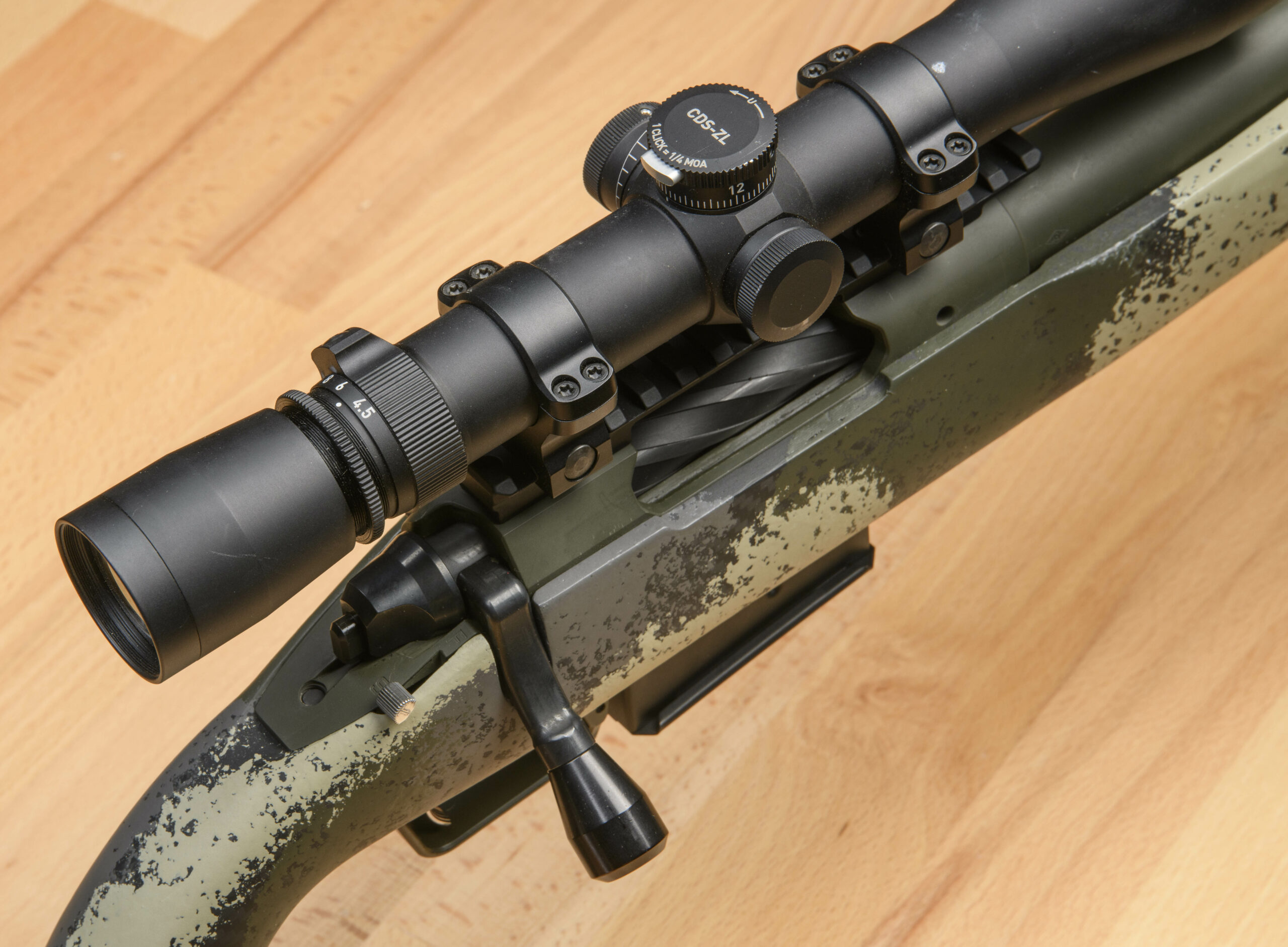 A black riflescope topping a camo-stocked Springfield Waypoint bolt-action rifle.