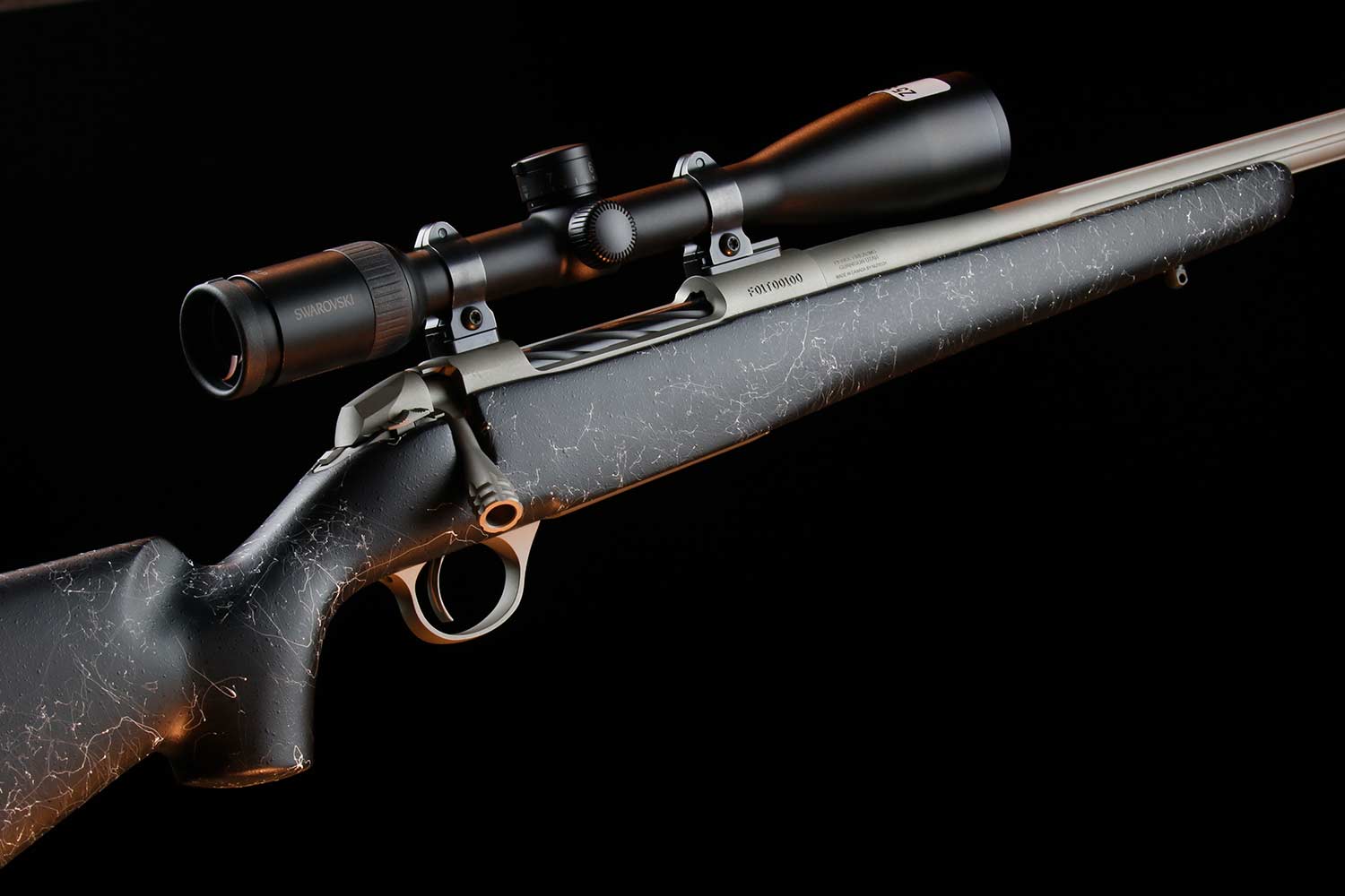 A hunting rifle on a black background.