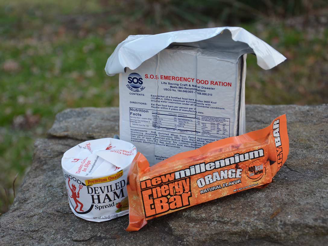 Three packages of dry goods on a rock.