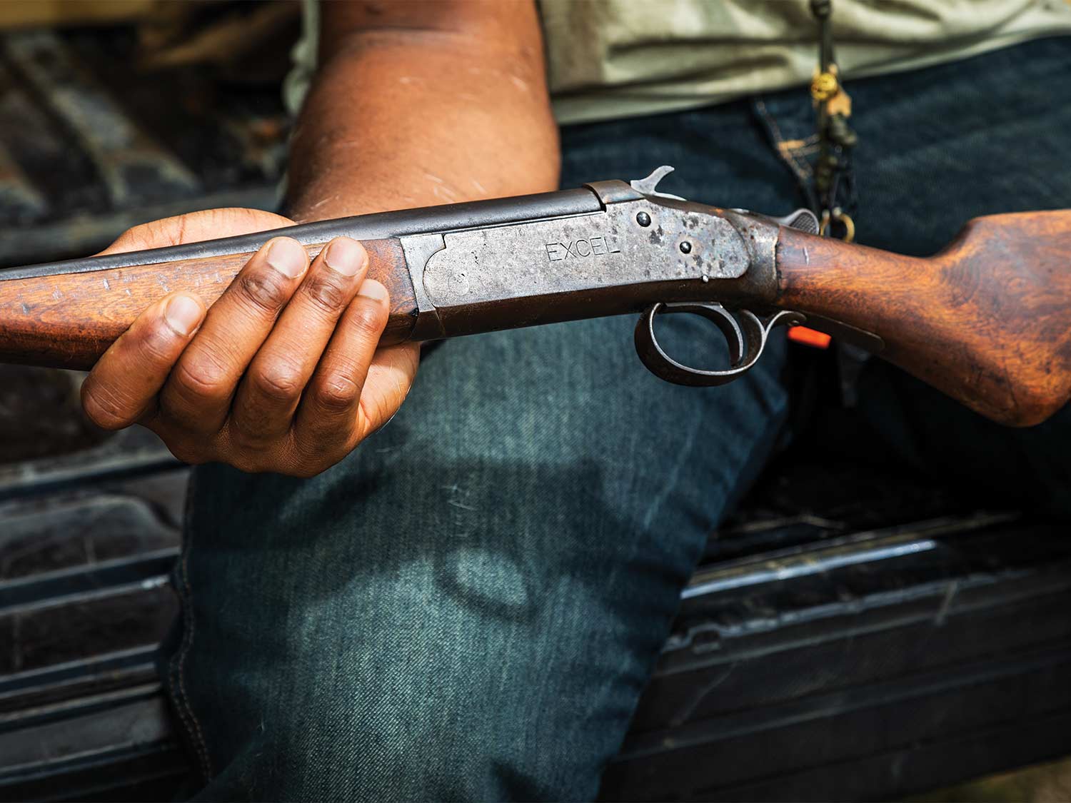Close up of a gun in a hunters lap.