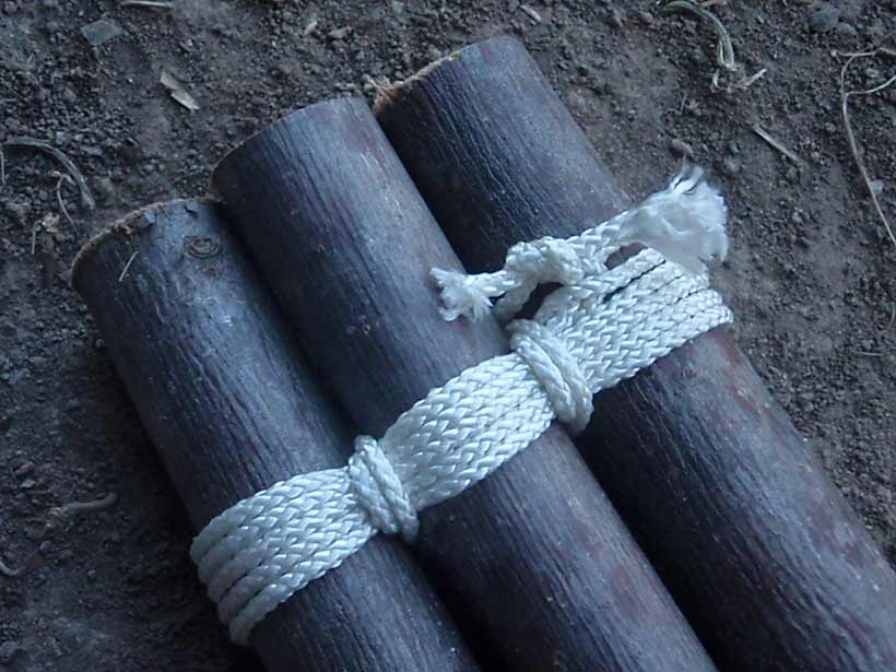 Three logs tied together with lengths of rope.