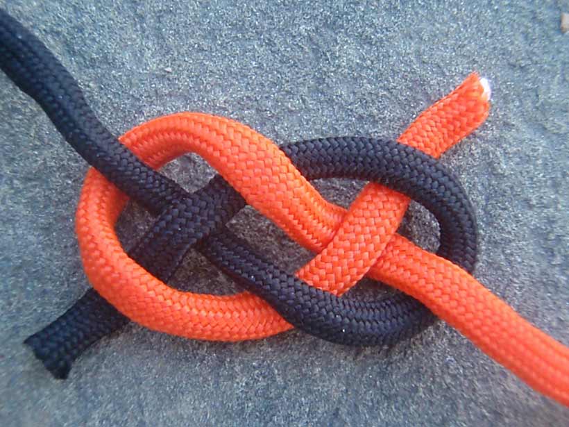 A length of orange rope tied together with a length of black rope.
