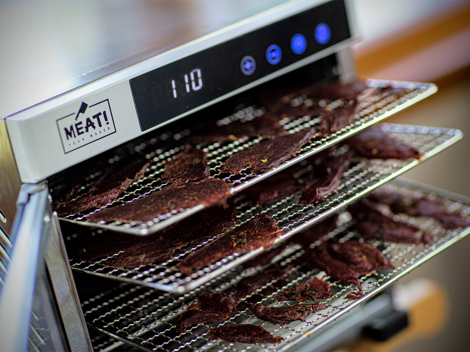 Racks of dried wild game jerk in a dehydrator.