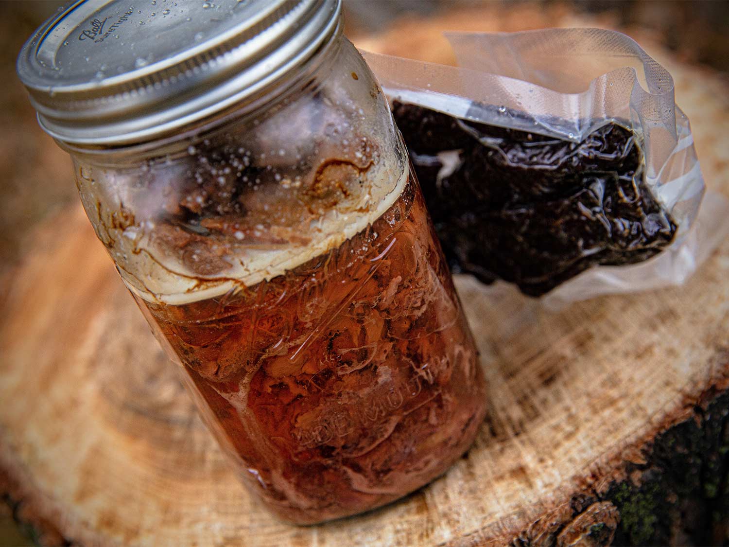 A sealed mason jar of canned meat.