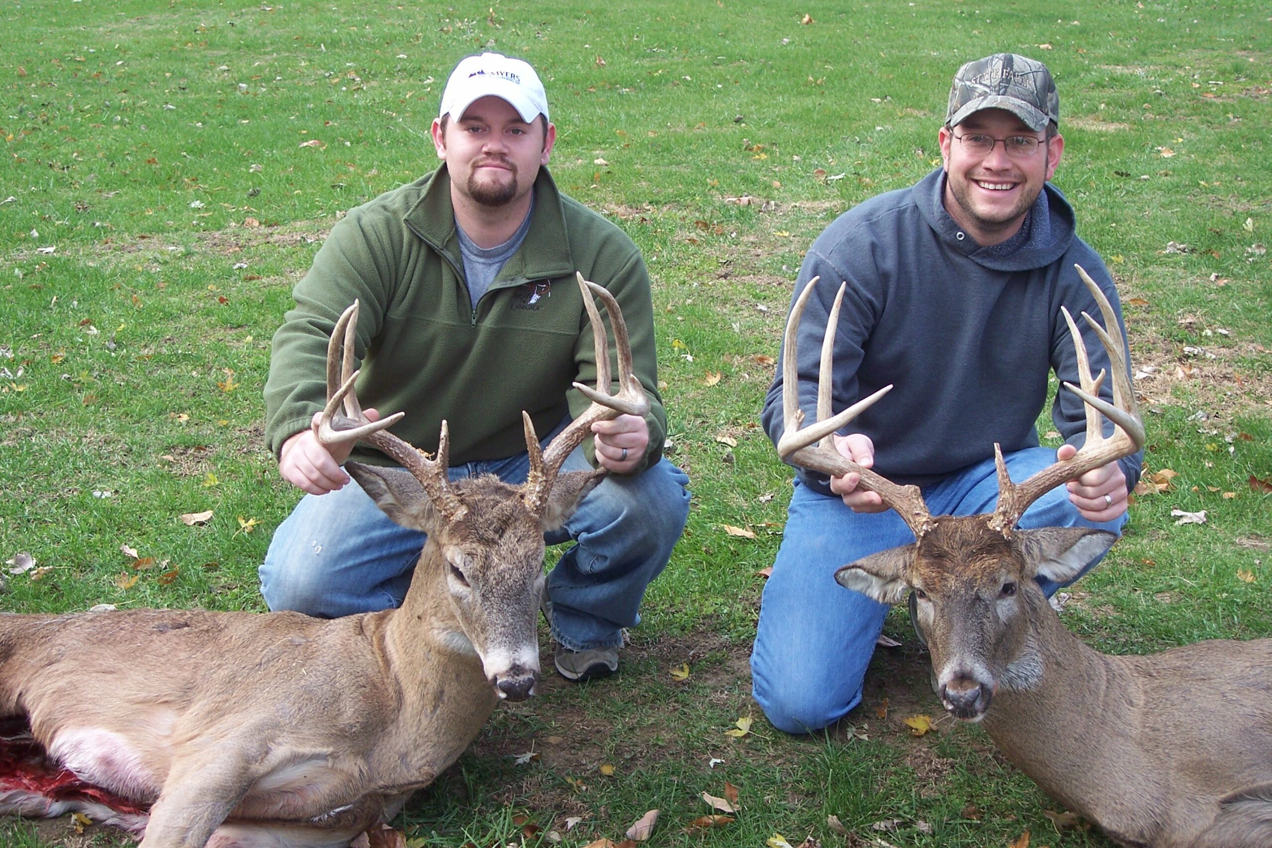 Two brothers with typical whitetail bucks.