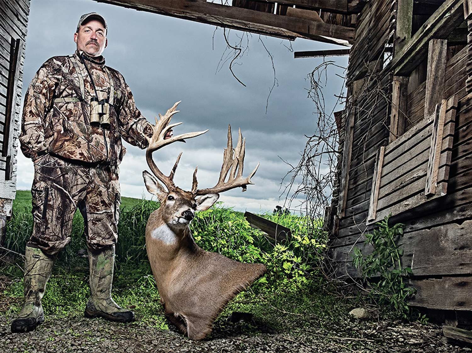 A hunter holds a whitetail deer trophy.
