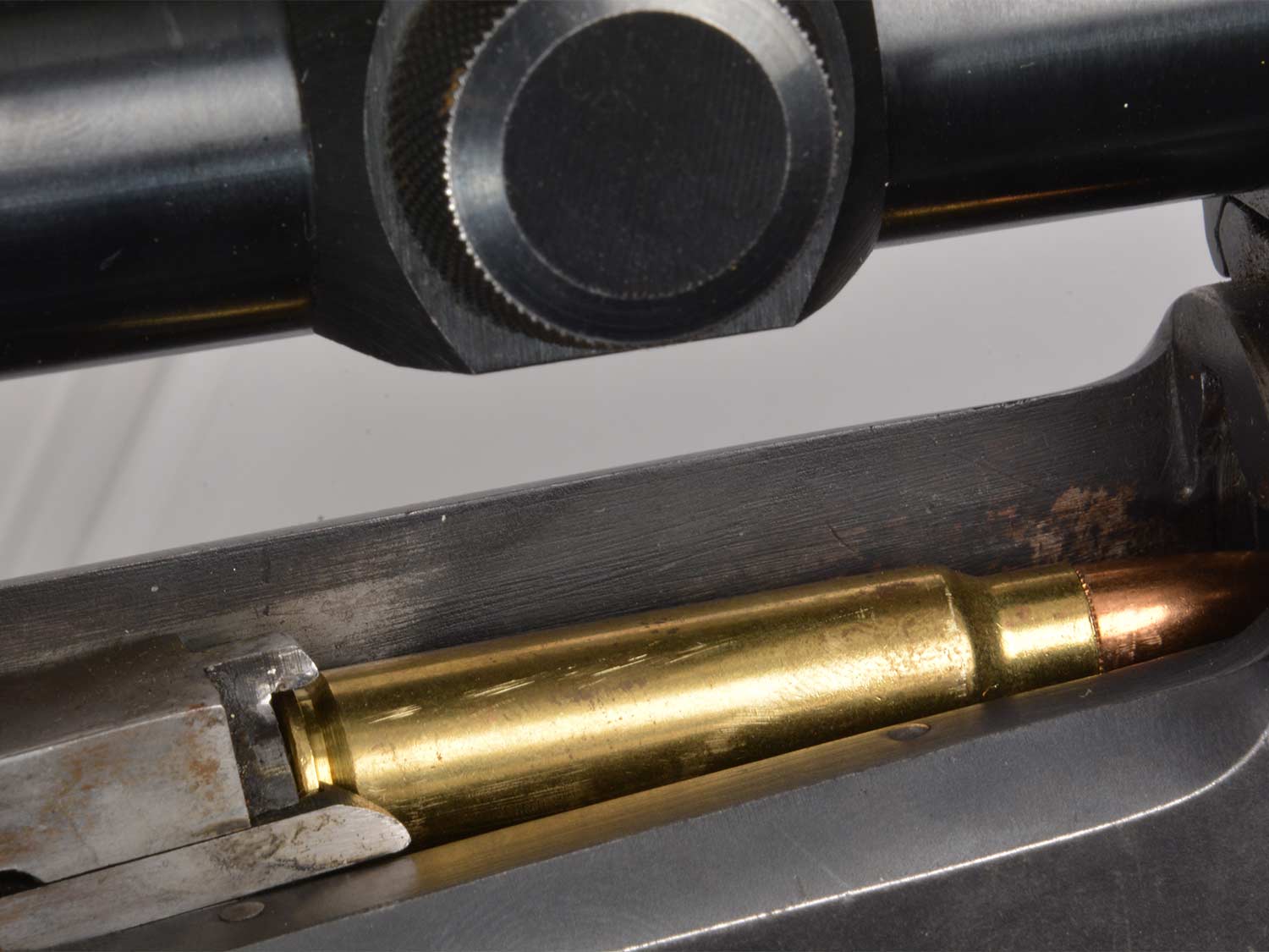 A bullet in the chamber of a Savage Model 99 lever action rifle.