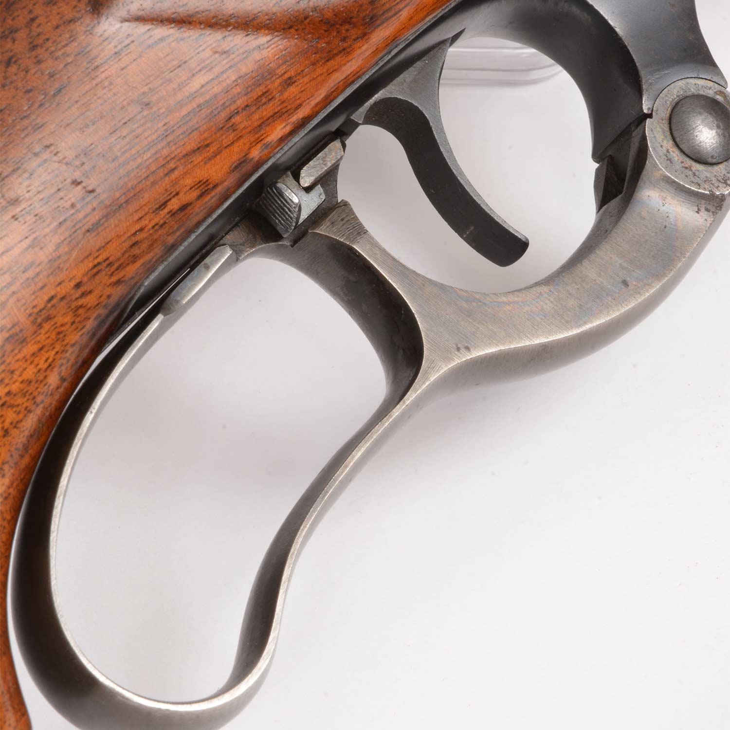 The lever, trigger, and safety detail of the Savage Model 99 lever action rifle.