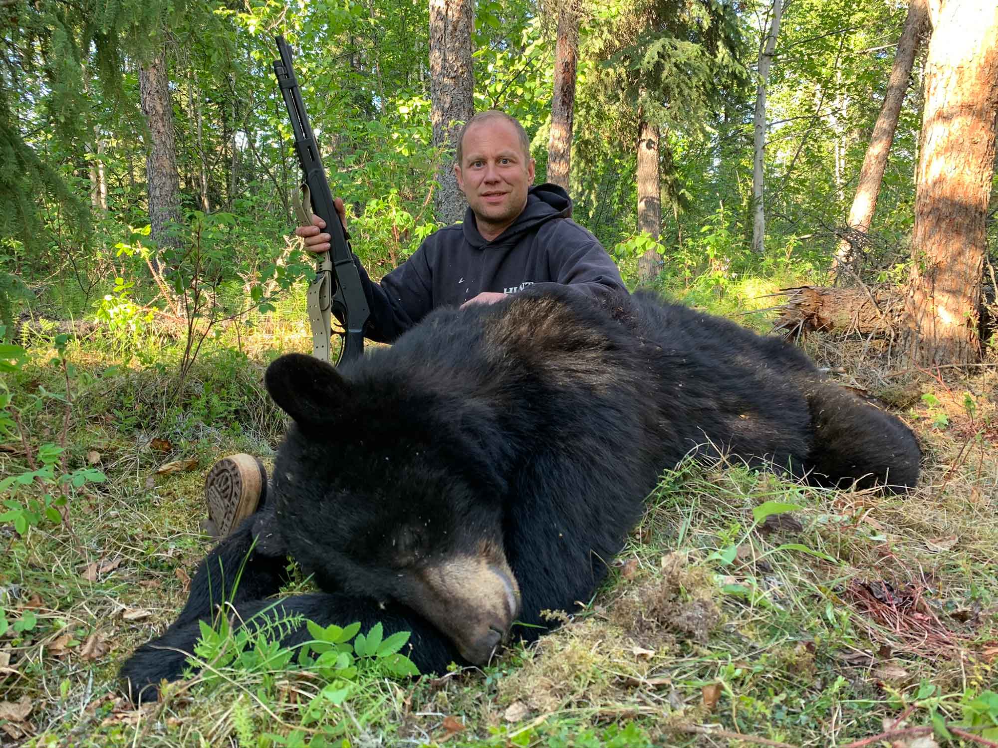 This bear was taken with a .45/70 lever gun after the boar peaked its head out from behind some cribbing.