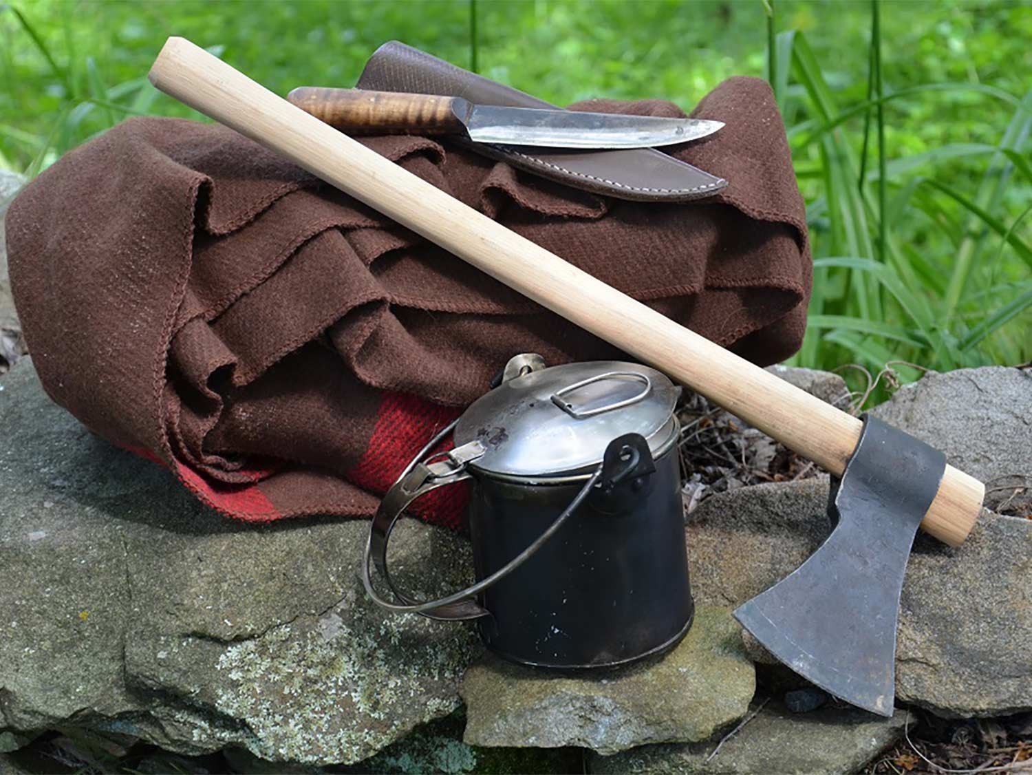 A collection of survival gear and a tomahawk.