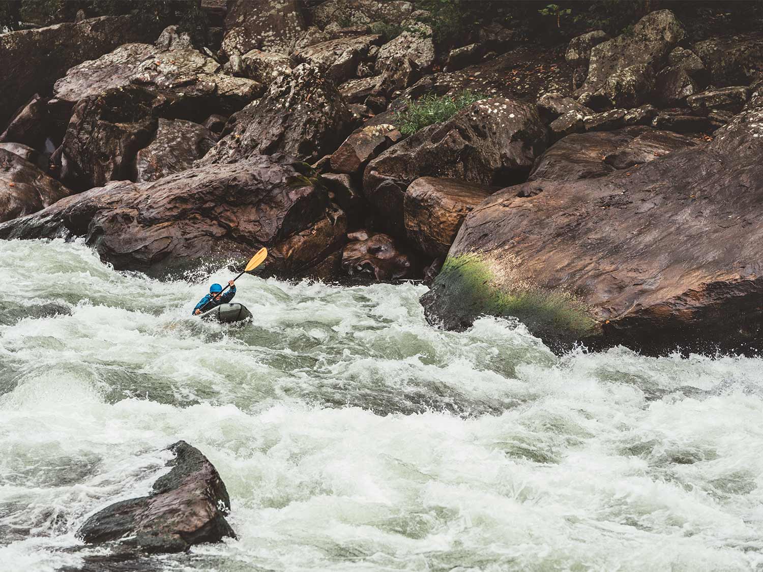 whitewater rafting down a river.