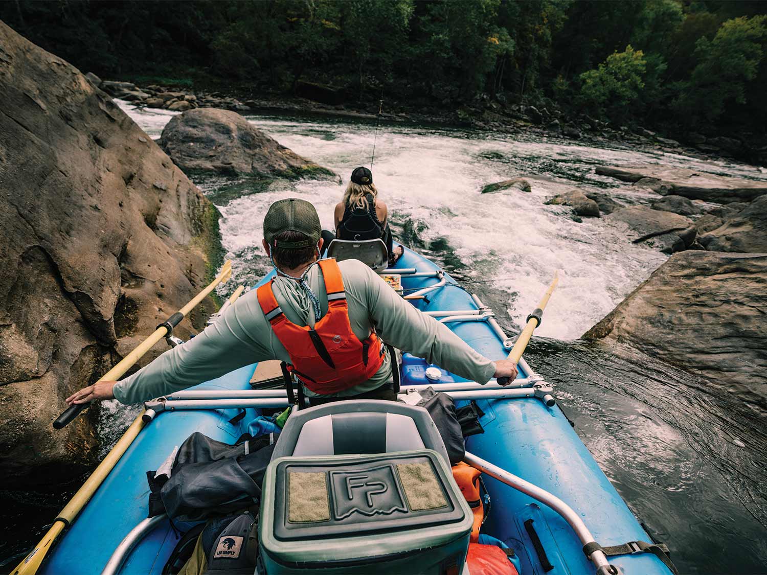 Anglers rafting down a river.