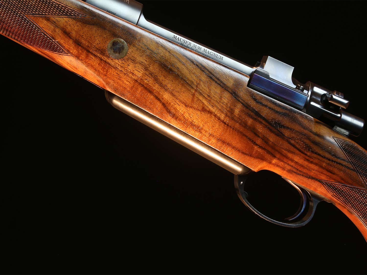 Close up detail of a rifle stock on a CRF Mauser rifle.