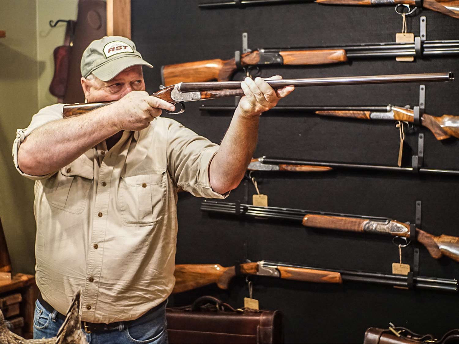 A man holds up a shotgun in a store.