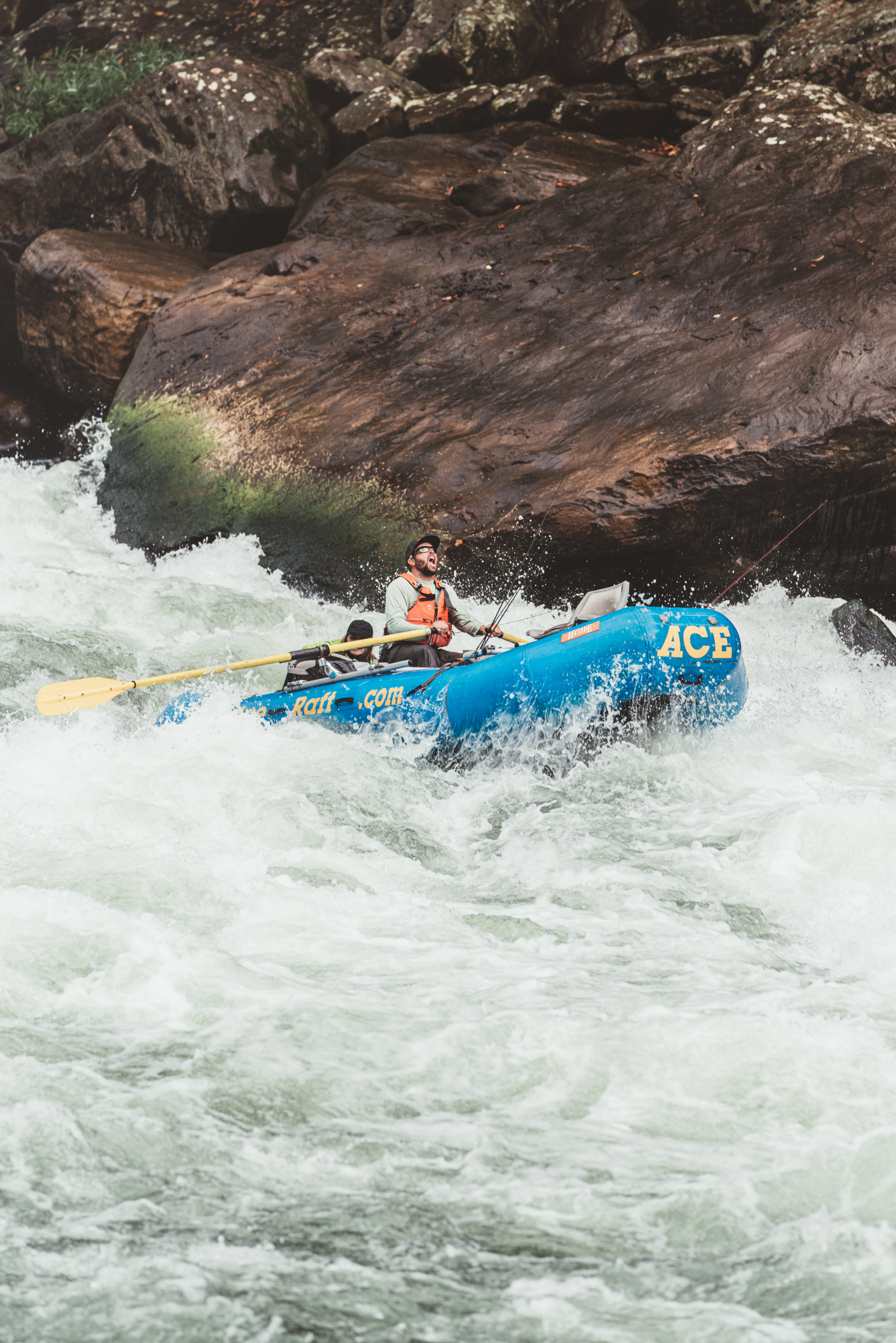 A fishing and rafting guide bombing down a rapid in an oar raft.
