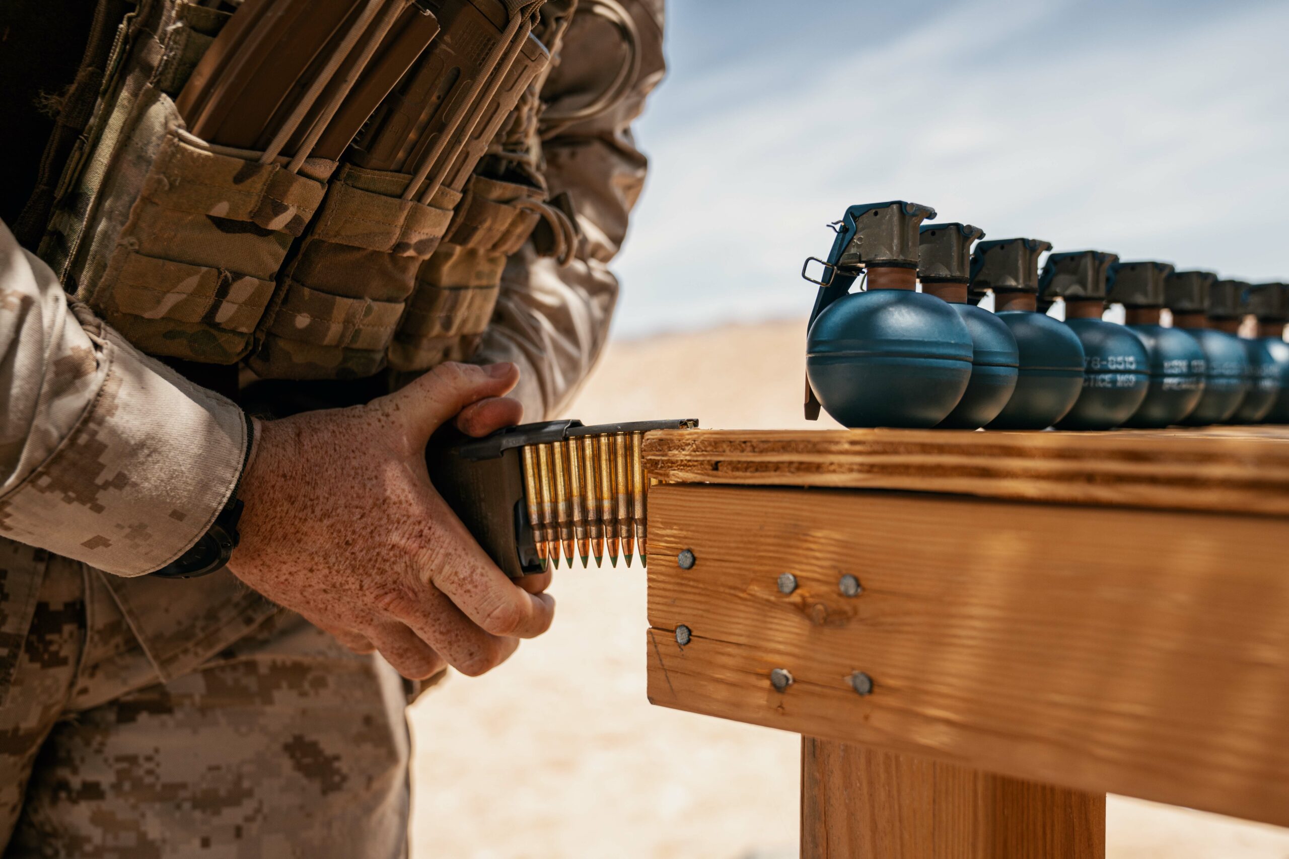 A Marine loads 5.56 rounds into a magazine before a live fire exercise.