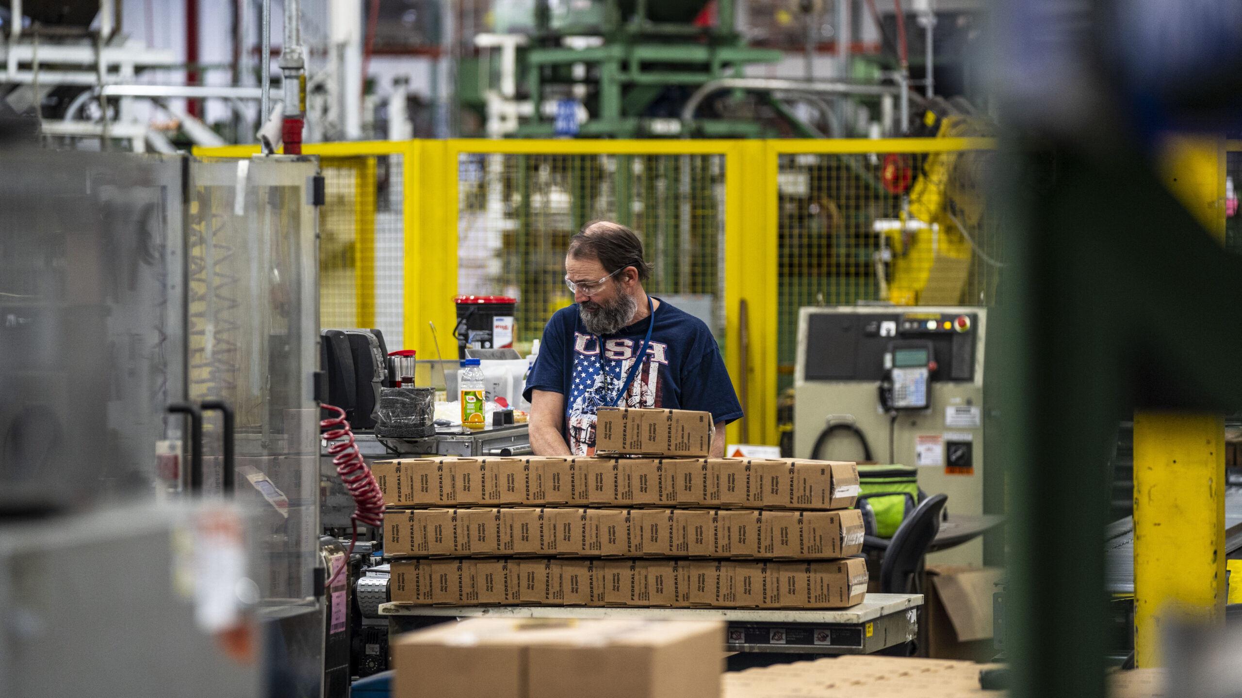 A Federal Premium factory work stacking up boxes for packing ammo.
