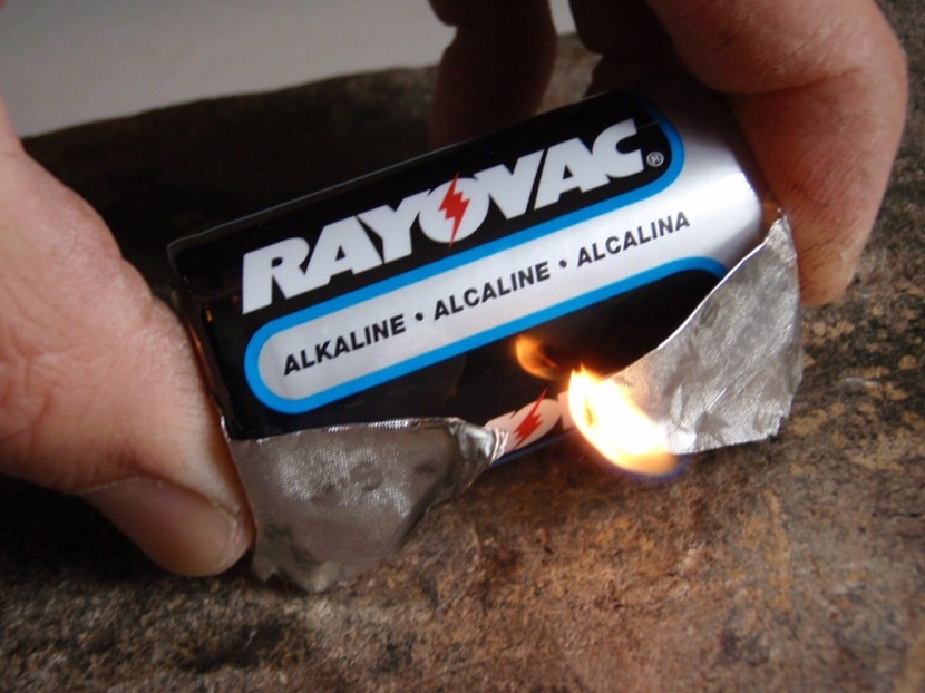 Lighting a fire with a gum wrapper and a battery.