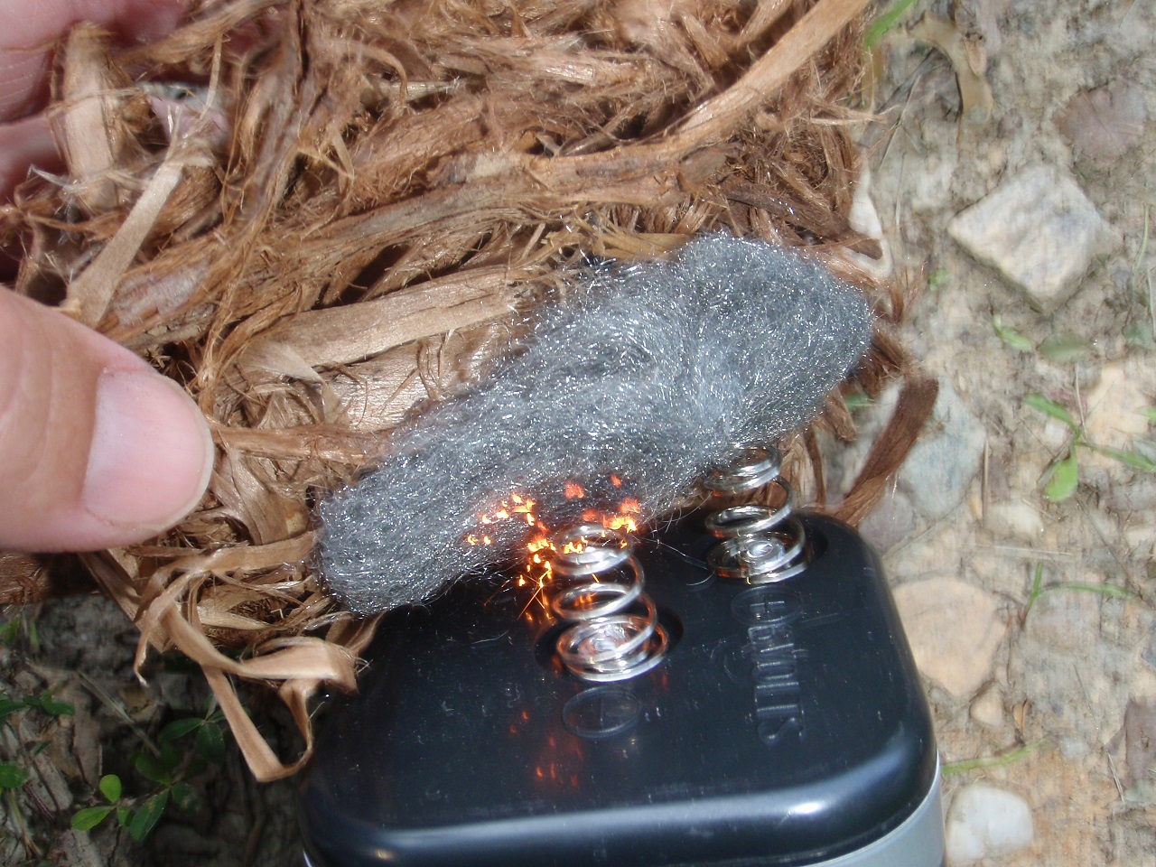 Using steel wool with a battery to start a fire.