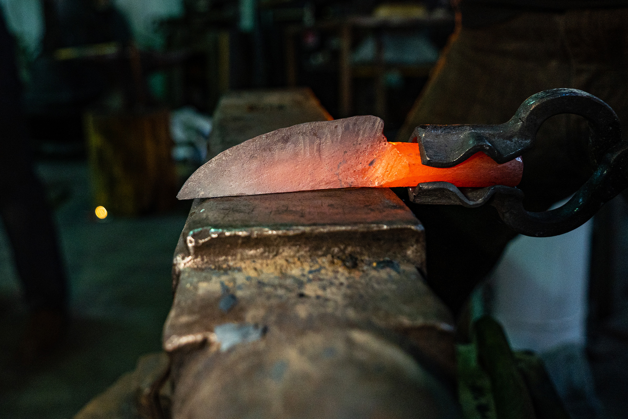 A piece of steel is being shaped into a knife.