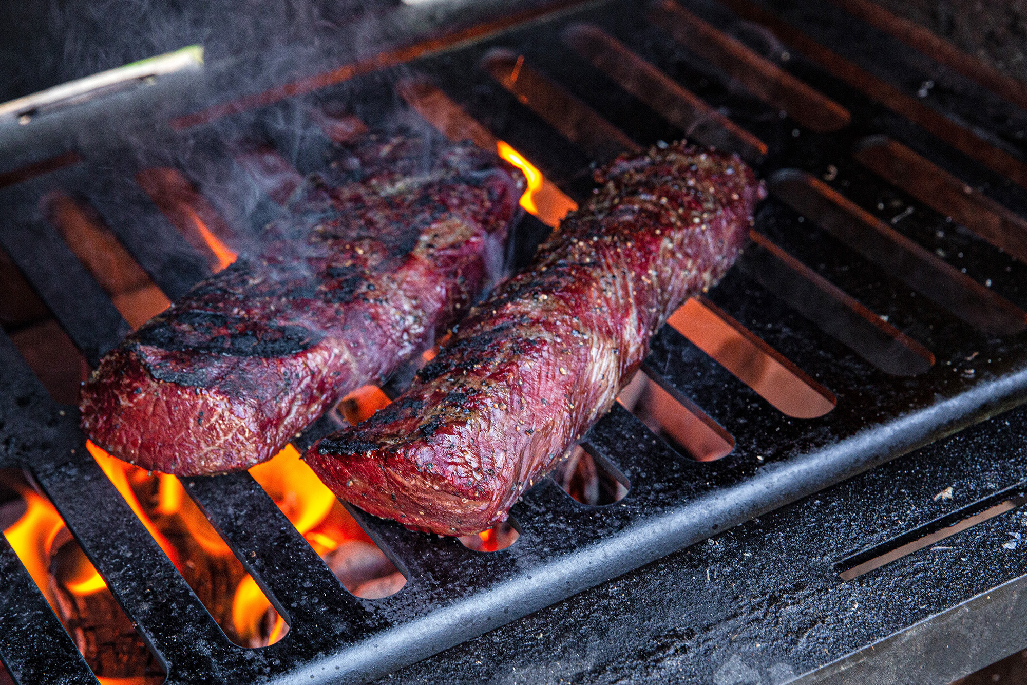 Wild game backstraps seared on a grill.