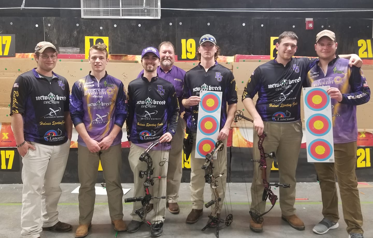 Bethel University archery team in 2018 with coach Kenny Louden at an archery competition.