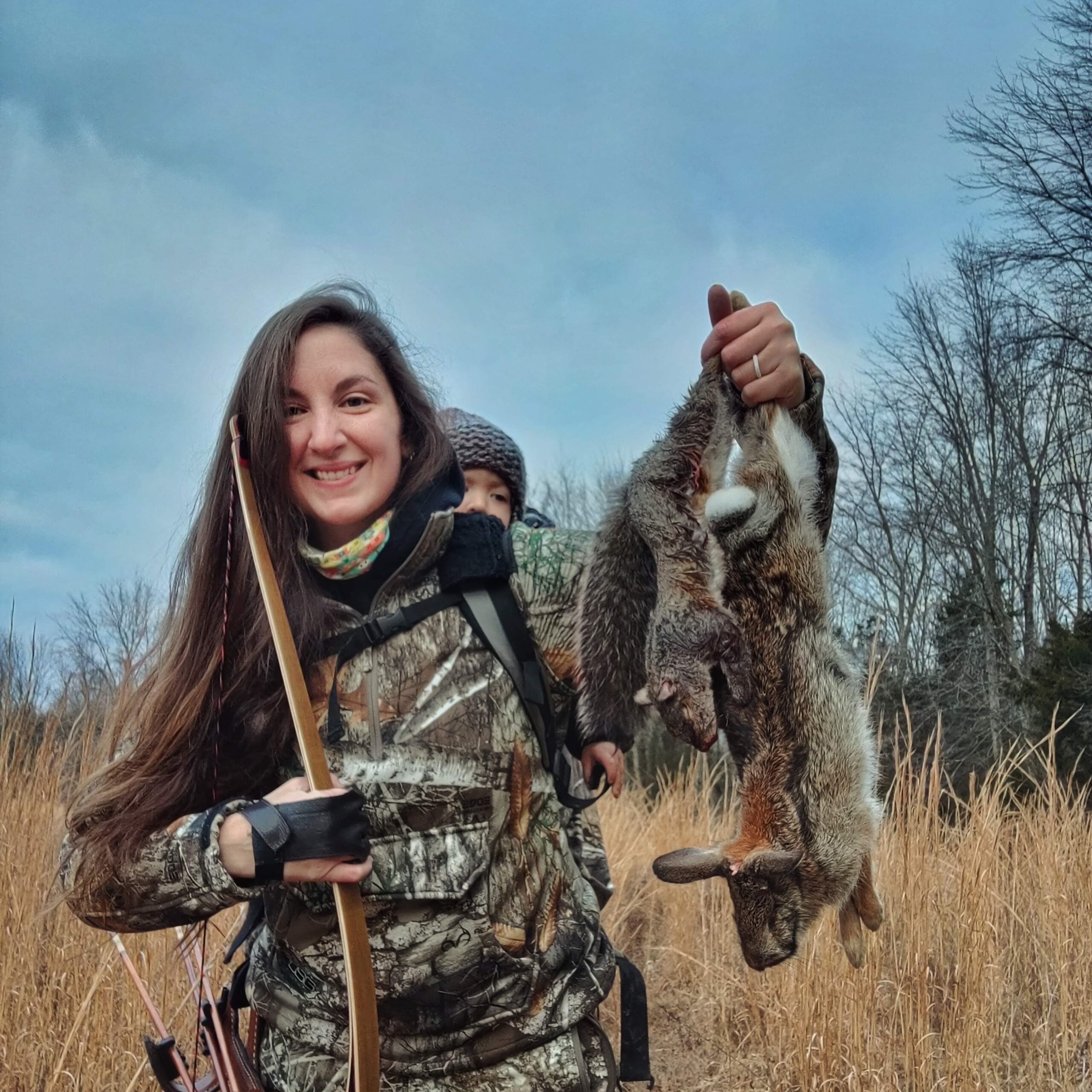 A bowhunter hunting with her daughter for small game.