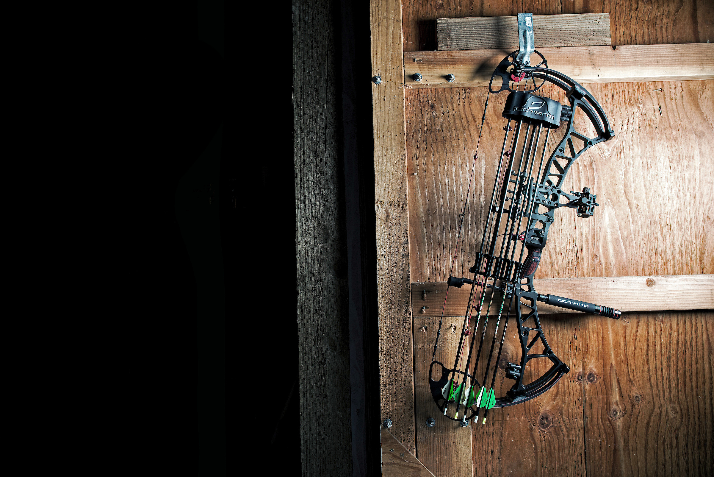Compound bow hanging on barn door