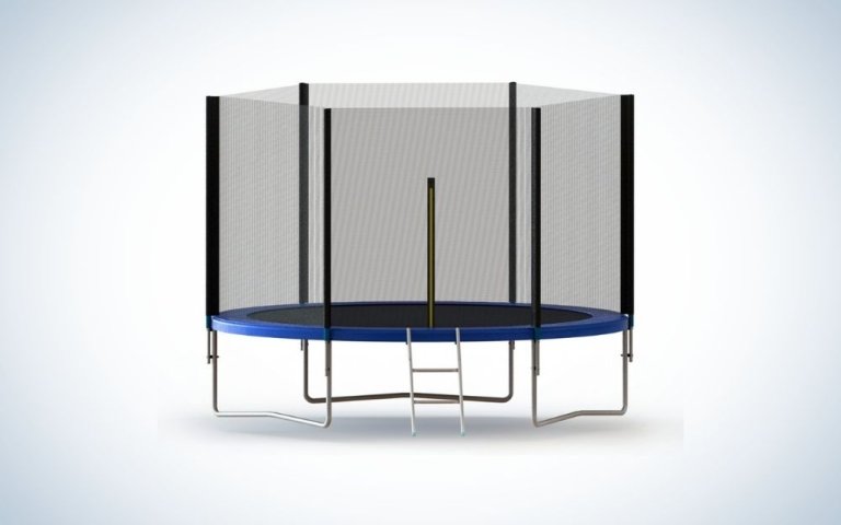 A circular trampoline with a black net and some silver metal legs and a few steps below it.