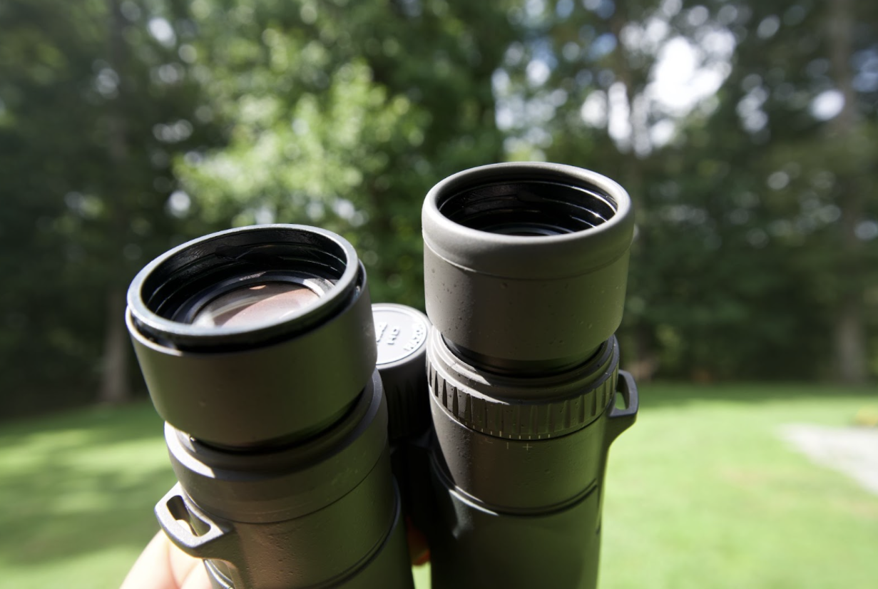 A pair of vortex razor hd binoculars with one rubber eyecup gasket