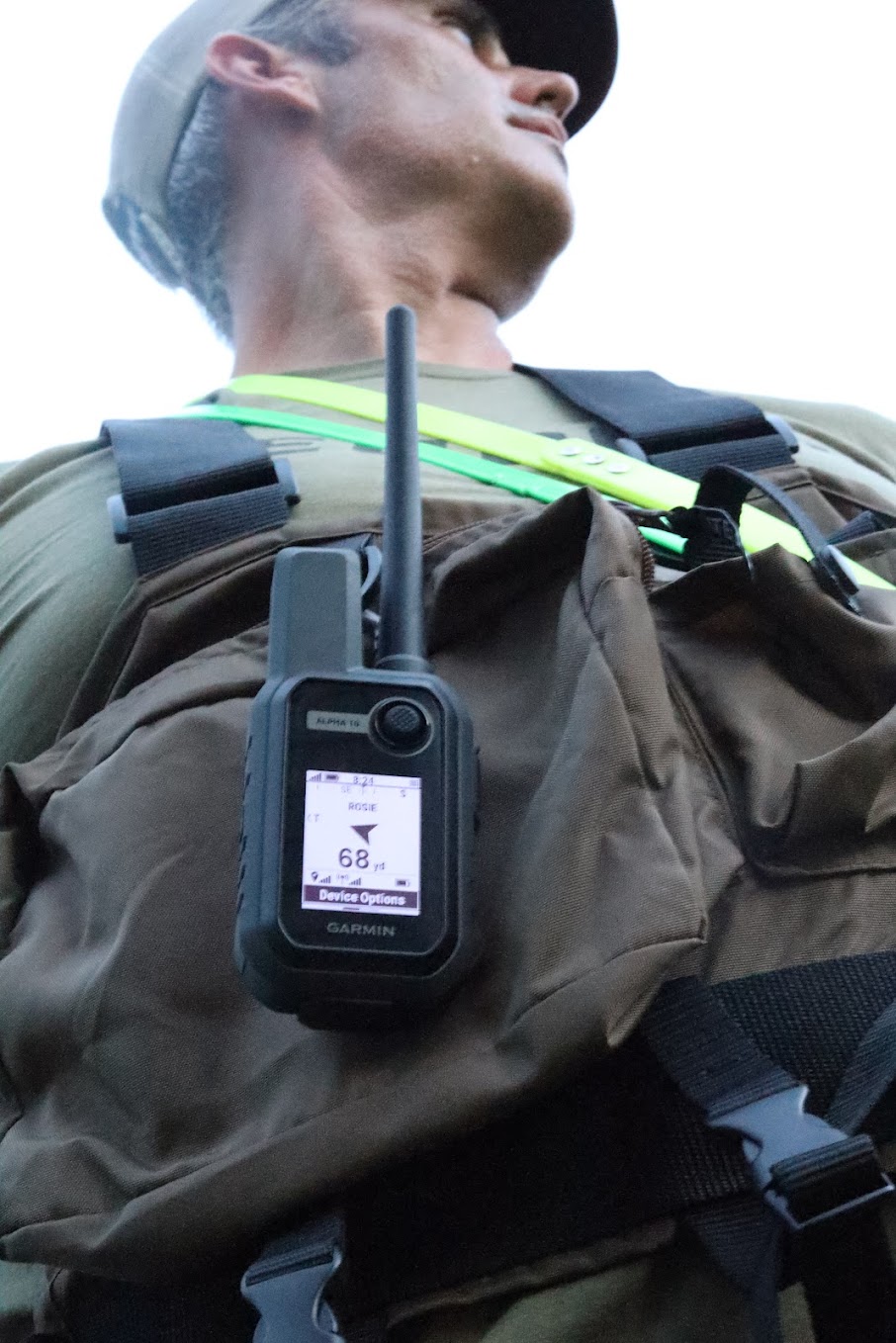 The Garmin Alpha 10 clipped to a hunter's vest
