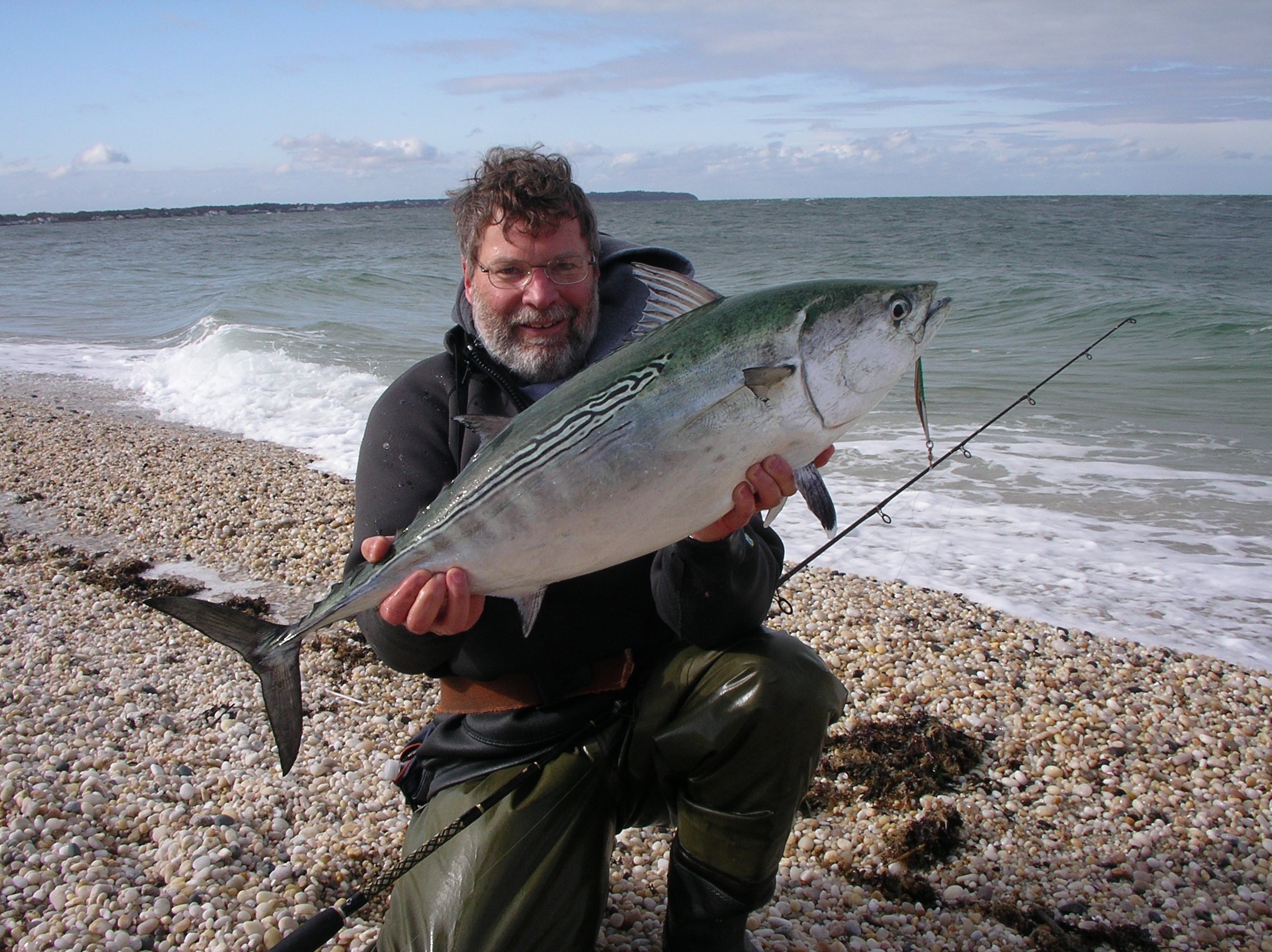 The author holding a large albacore next to the ocean