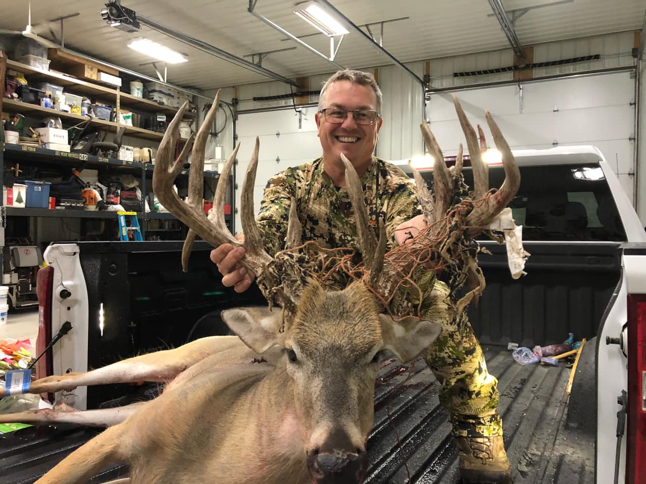 Mike Beadle with his buck in the bed of his pickup in South Dakota.