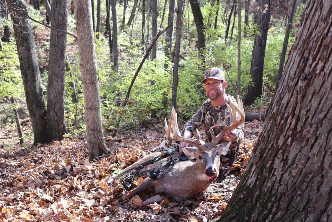 Bowhunter with whitetail buck