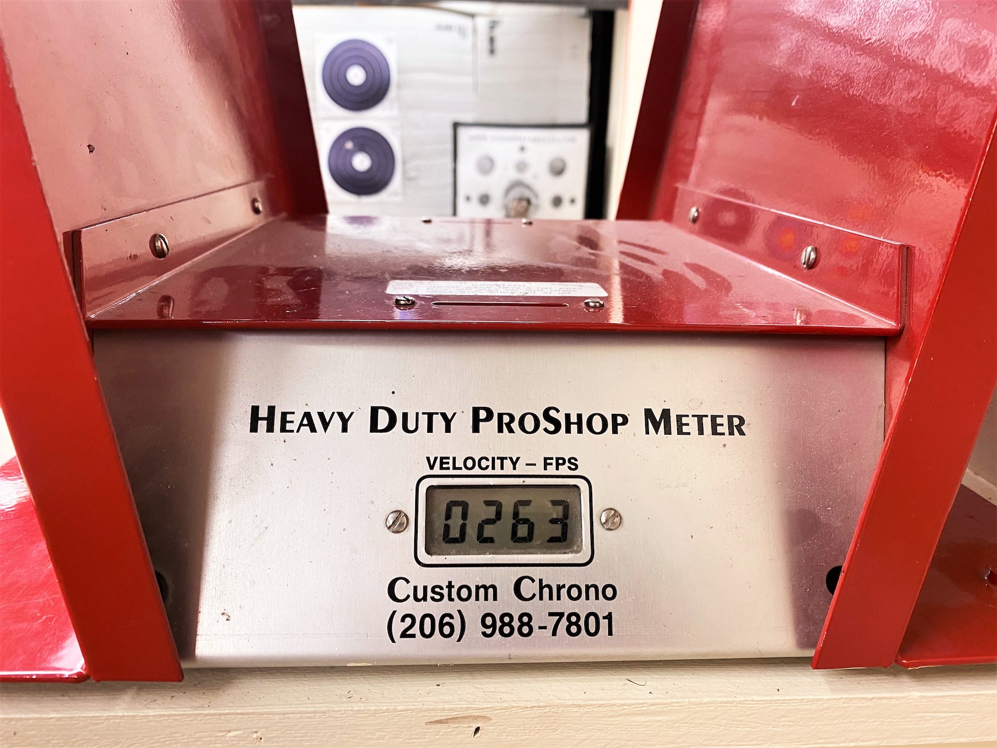 A close-up of a red and silver Custom Chrono Heavy Duty ProShop Meter