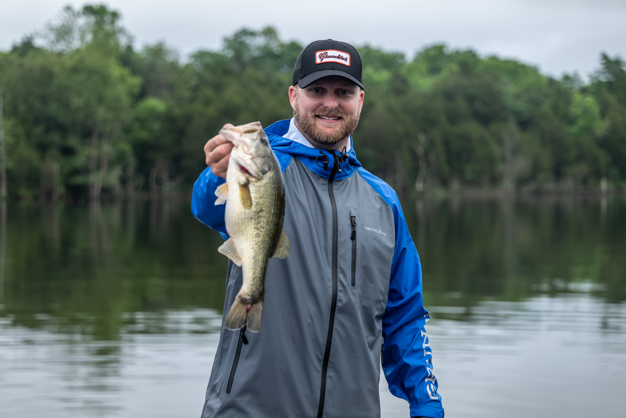 Angler holds fish wearing Grundens Tourney