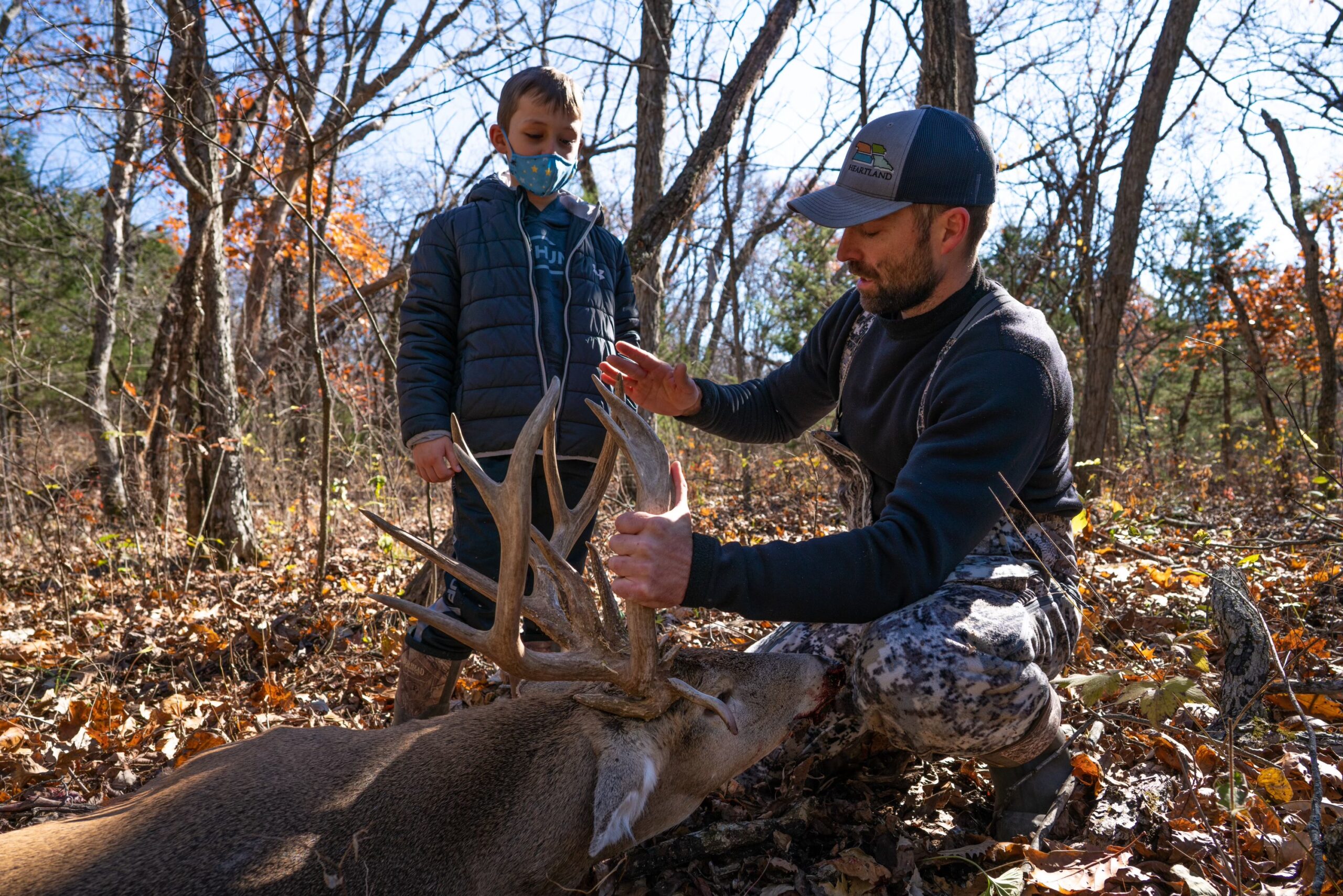 Two hunters admire the antlers of a big Kansas buck.