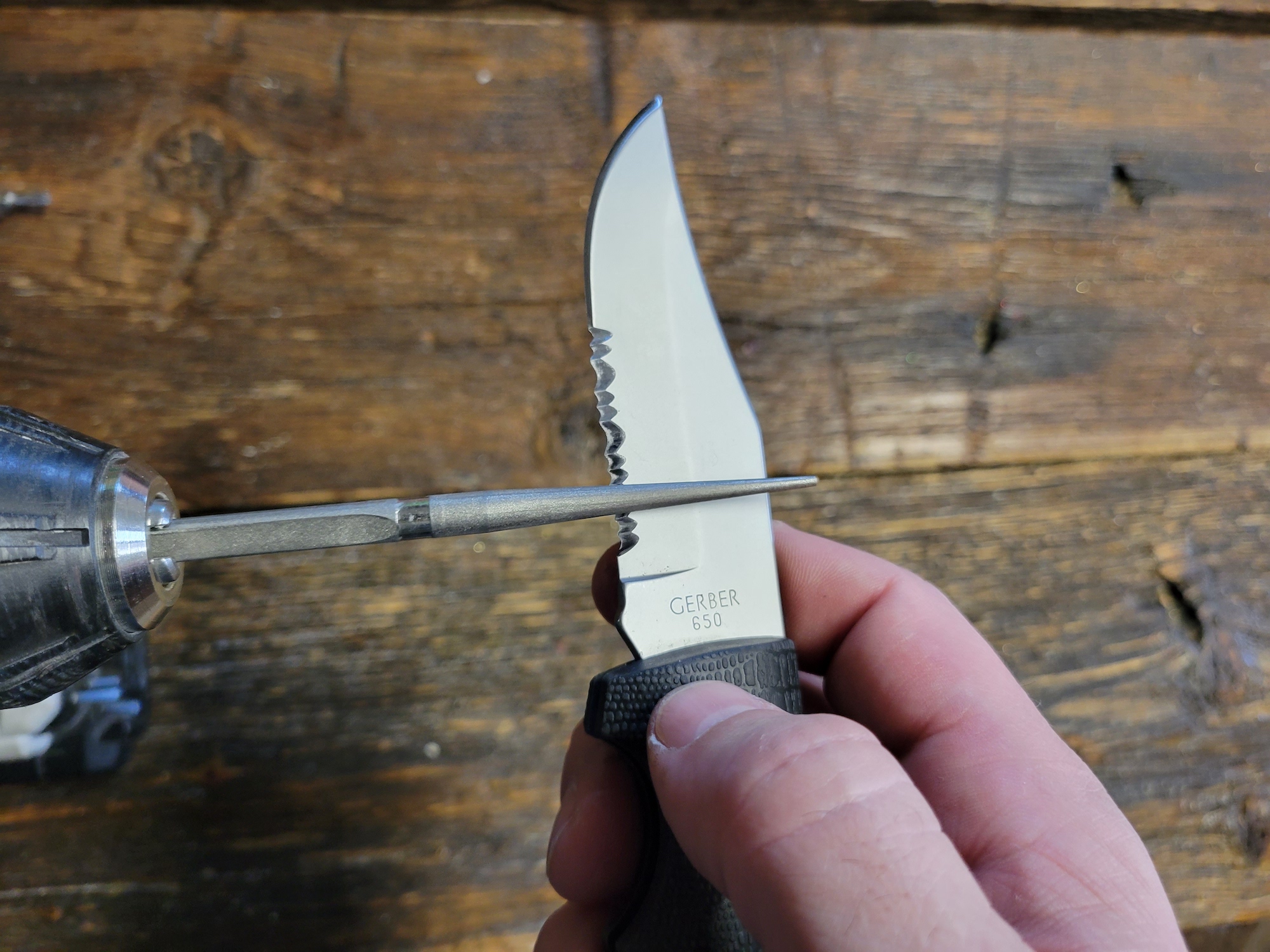 A knife sharpener sharpening a serrated blade