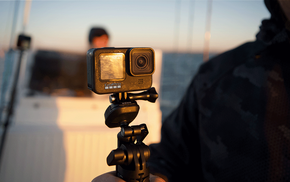 A mounted small black camera on a boat