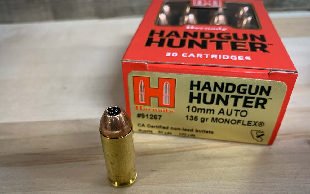 A red box of 10mm ammo next to a gold bullet