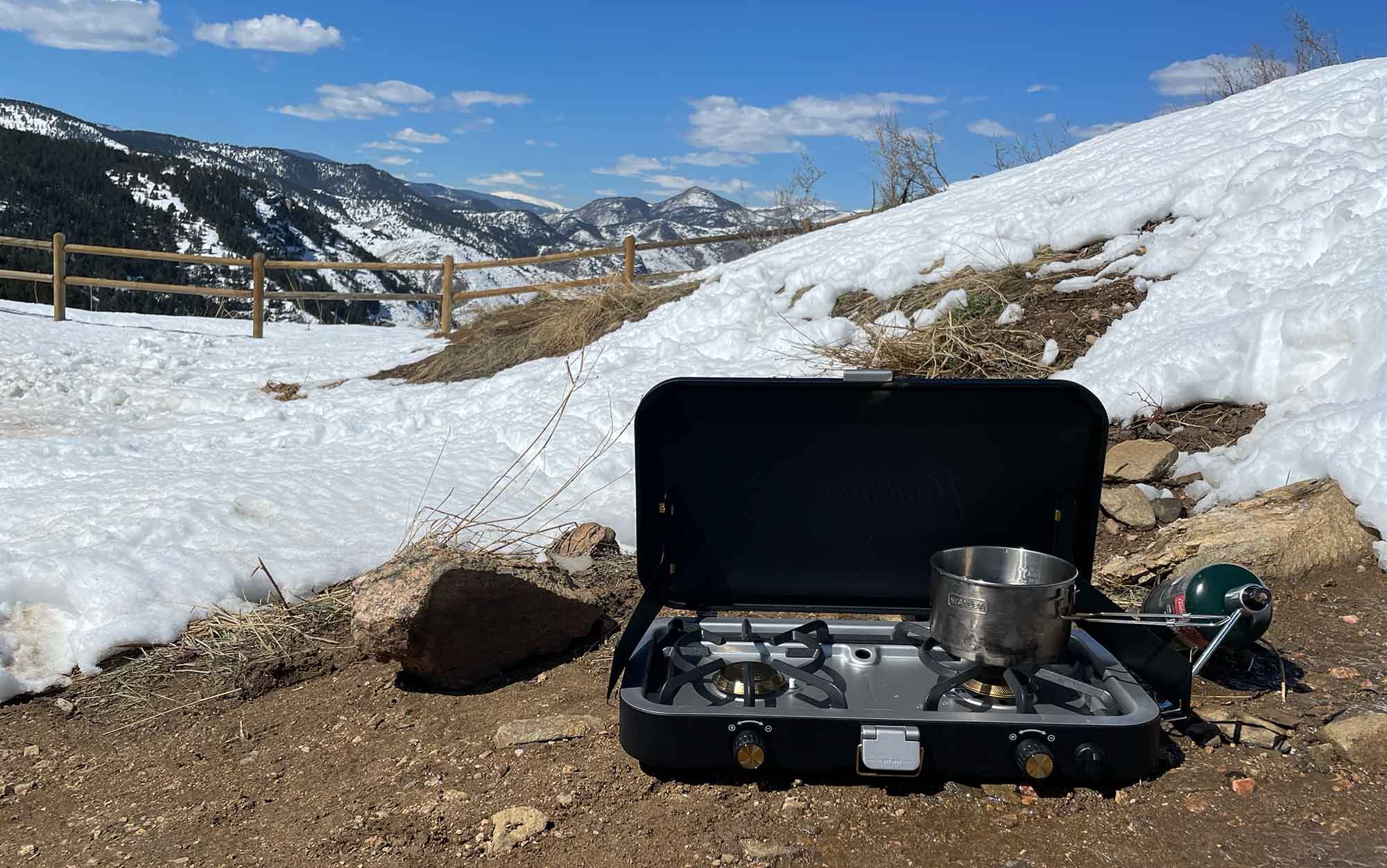 One of the best camping stoves sits in front of the mountains.
