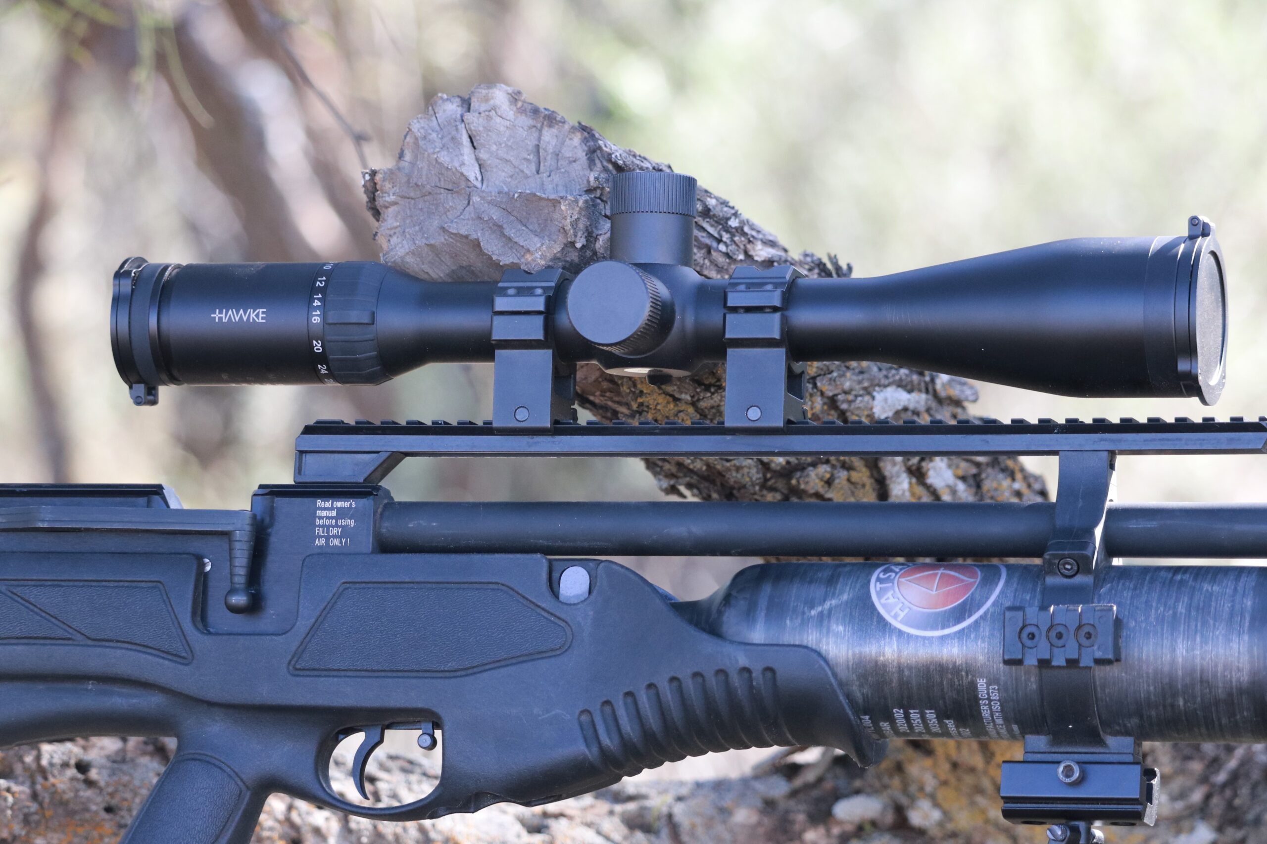 A black best air rifle scope mounted on a black air rifle