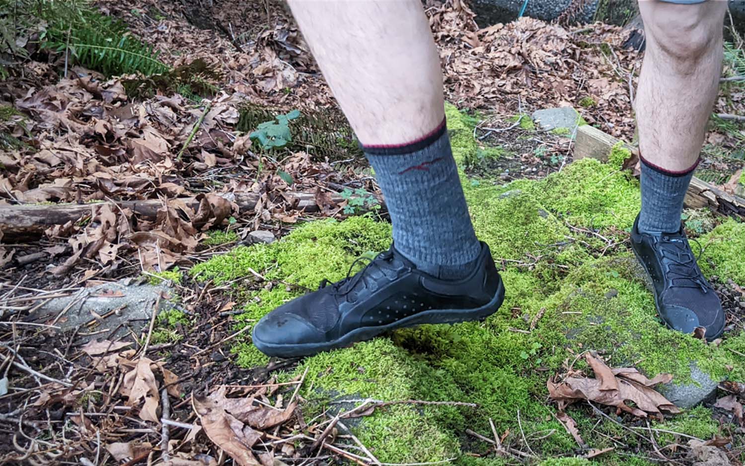 A man's legs with a close up of grey hiking socks