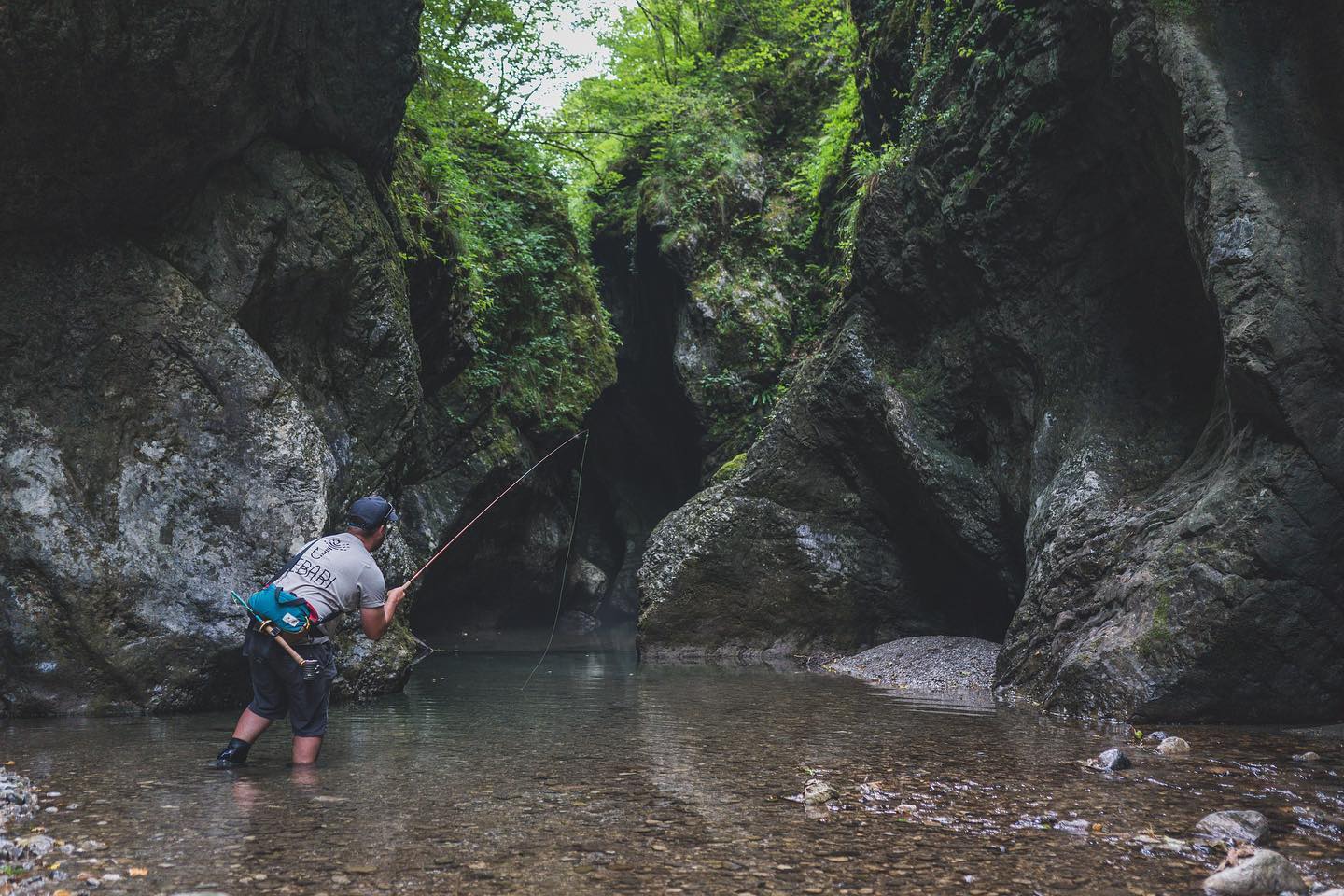 A man fishing in a cave with a tenkara rod